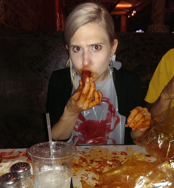A woman enjoying a slice of pizza.