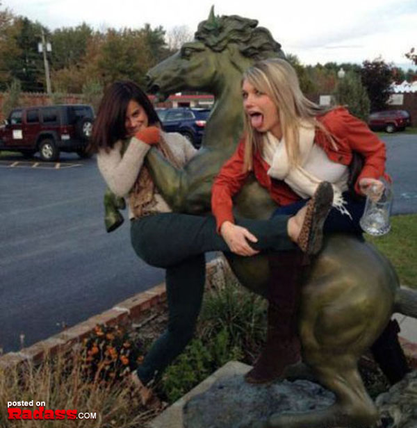 Two women are playing with a statue of a horse, but there's an undercurrent of 