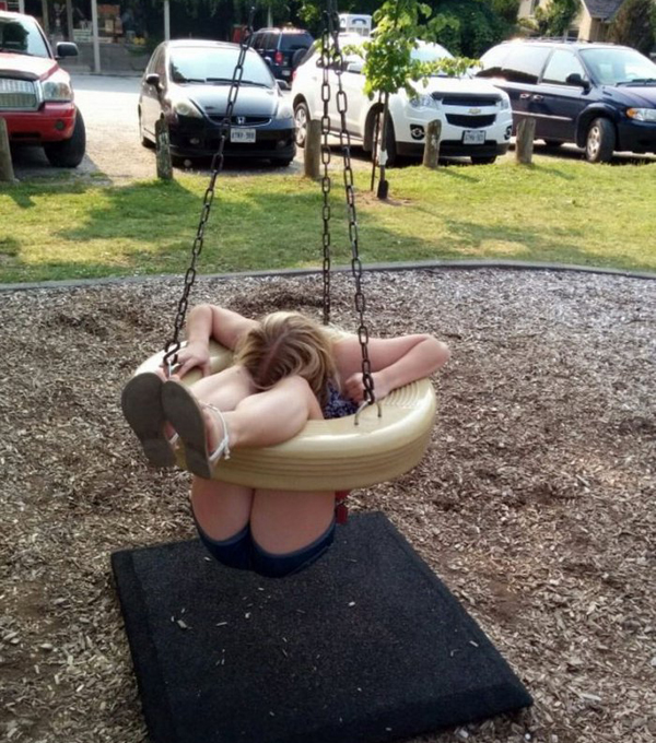 A girl swinging in a park.