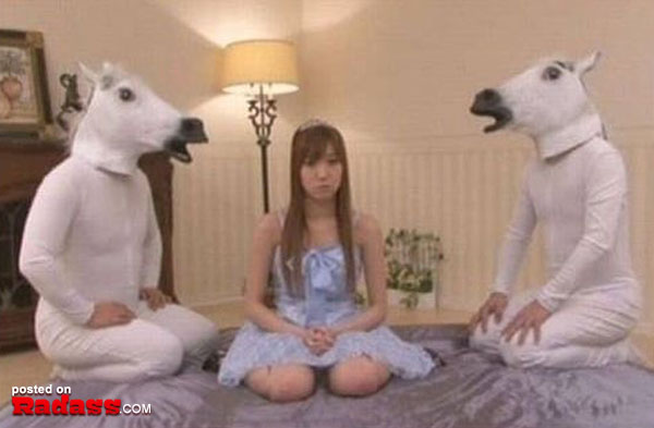 A girl dressed as a horse sits on a bed, making for an intriguing scene.