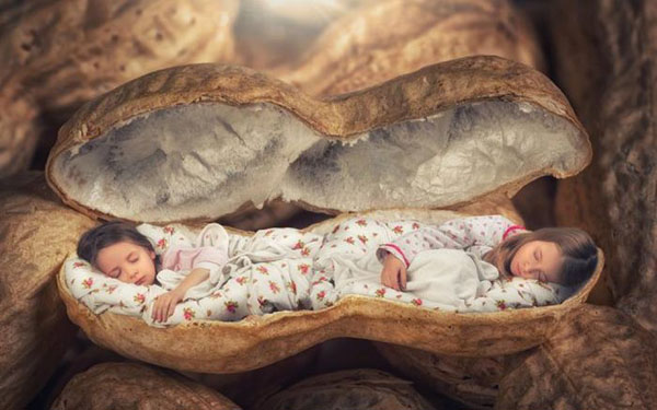 John Wilhelm Turns Everyday Photos Into Two children sleeping in a shell Masterpieces.