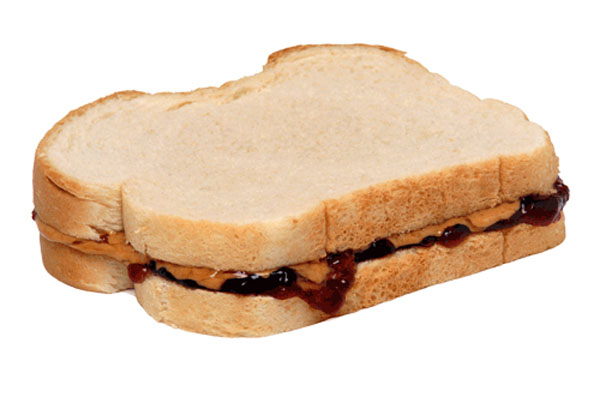 A college student's familiar peanut butter and jelly sandwich on a white background.