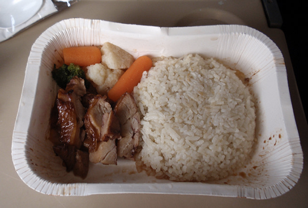 A tray with rice, carrots, and meat that serves as a familiar meal for college students.