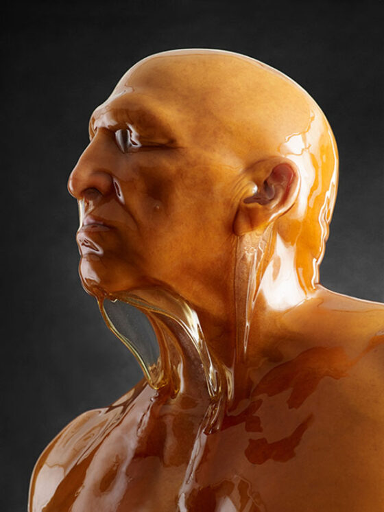 A statue of a man completely drenched in liquid.