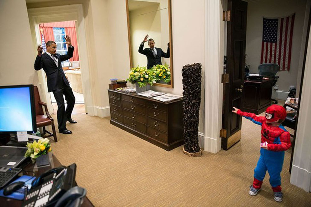 President Barack Obama dressed as Spider-Man in the Oval Office, captured by The White House's Pete Souza.