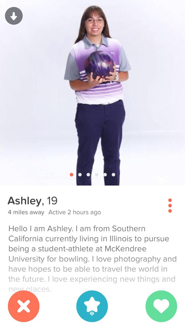 A woman is standing in front of a phone screen, browsing through her top Tinder finds for the week.