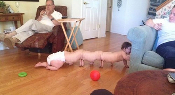 A baby crawling on the floor captures a heartwarming moment of innocence.