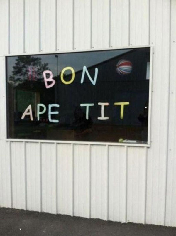 Bon ape tit in the window of a building, reminding us of 18 People Who Should Learn to Proofread.