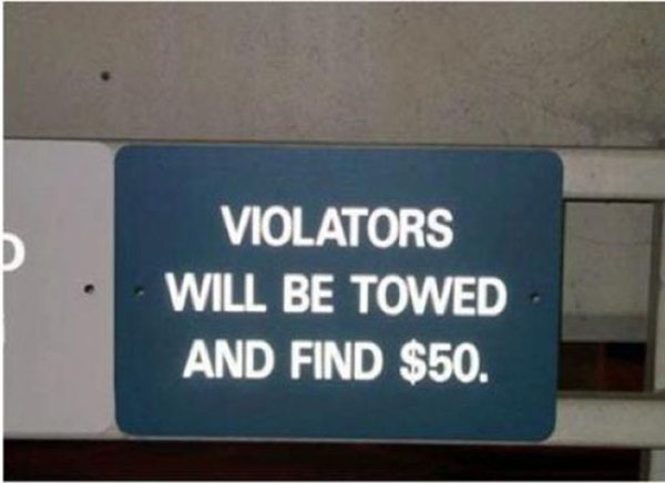A sign that says violators will be towed and fined $50.