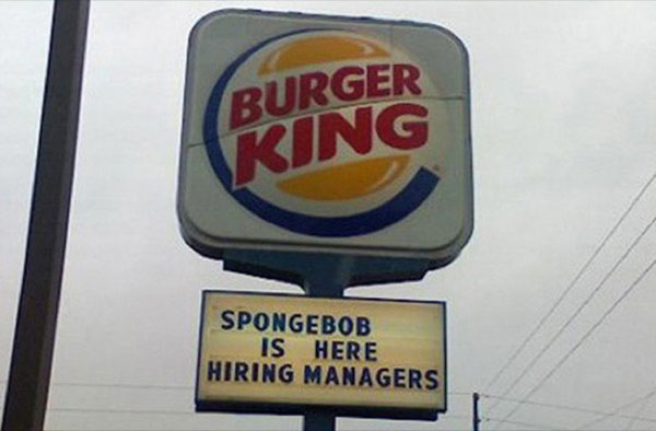 A sign that says Burger King is hiring managers.