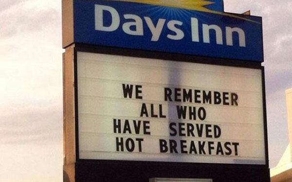 A sign that says Days Inn, serving hot breakfast and honoring those who have served.