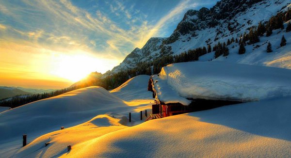 Saturday Morning Cool Pics (44 Photos): The sun is setting over a snow covered mountain, creating a mesmerizing view.