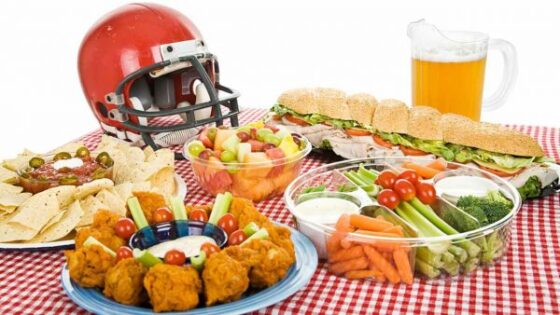 Super Bowl Sunday: A checkered table and a football helmet dominate this festive scene of food.