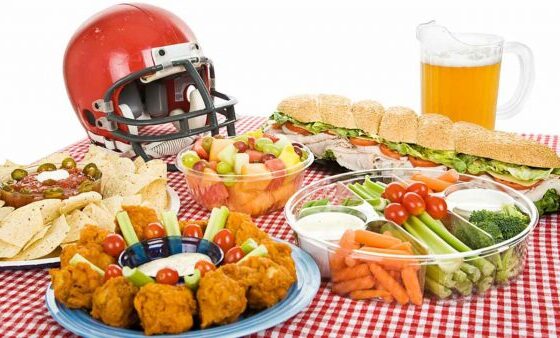 Super Bowl Sunday: A checkered table and a football helmet dominate this festive scene of food.