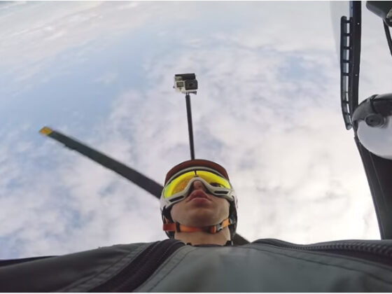 A man wearing goggles is flying in a plane, experiencing the thrill of tour Panama City from above.