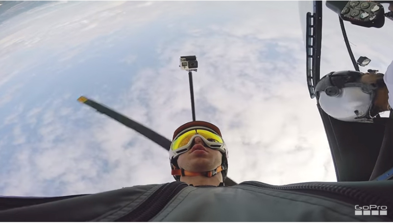 A man wearing goggles is flying in a plane, experiencing the thrill of tour Panama City from above.