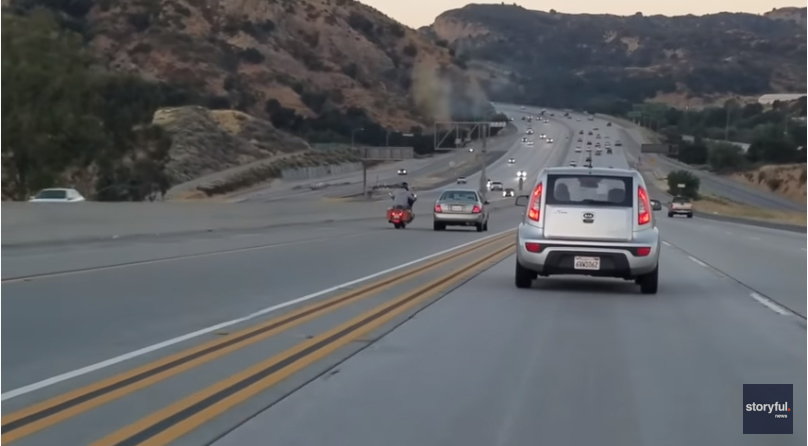 In a bizarre and alarming twist of events, a car driving down a highway finds itself caught in an escalating confrontation with another driver. The situation quickly becomes extremely intense, as both vehicles navigate through