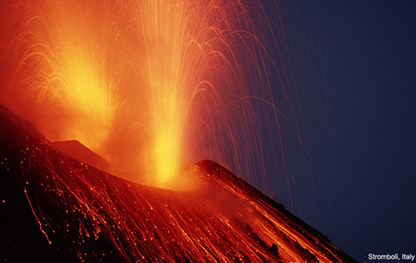 Volcanoes spewing lava at night.