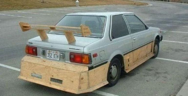 A WTF car with a wooden frame parked in a lot.