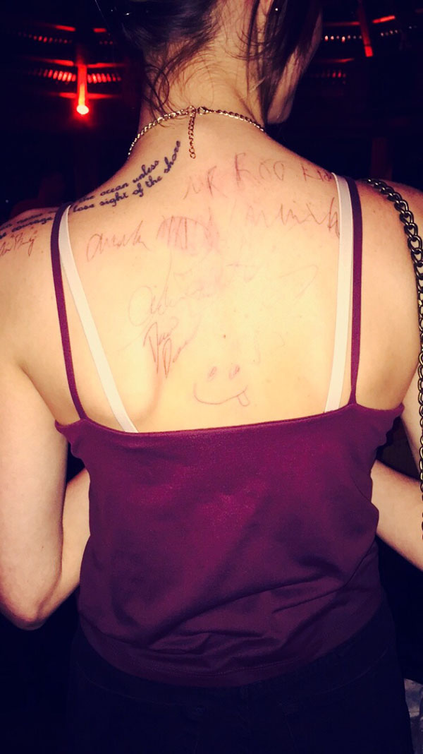 A person with a tattoo on their back, displaying their Weekend Confessions.