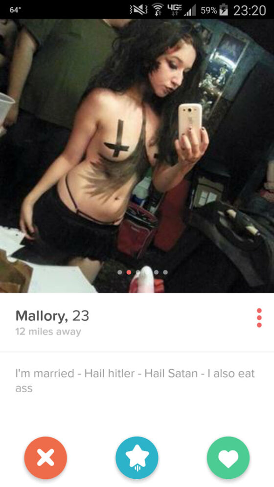A woman is taking a picture of herself on her phone for one of the top Tinder finds for the week.
