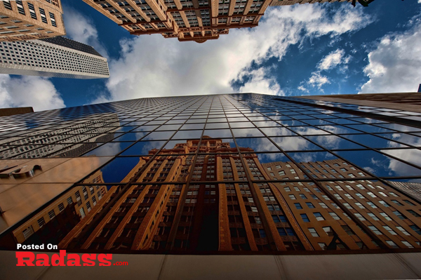 A captivating HQ photograph showcasing the beautiful architecture of a skyscraper reflected in a glass building.