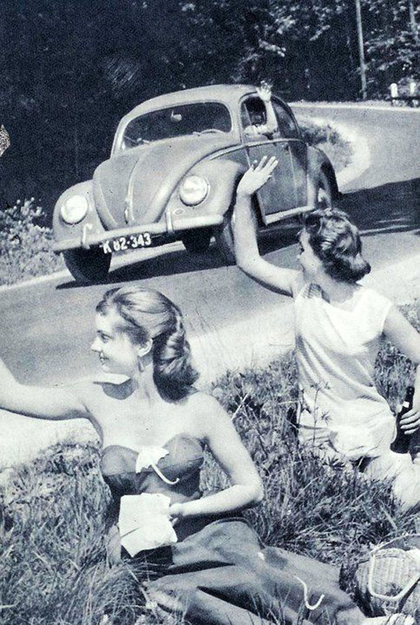 A vw beetle cruising with style on the road.