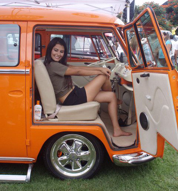 An orange VW bus filled with babes and dubs.