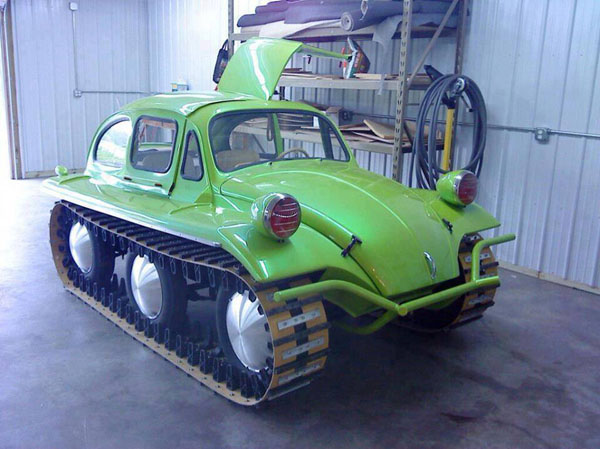 A cool green VW Beetle parked in a garage.