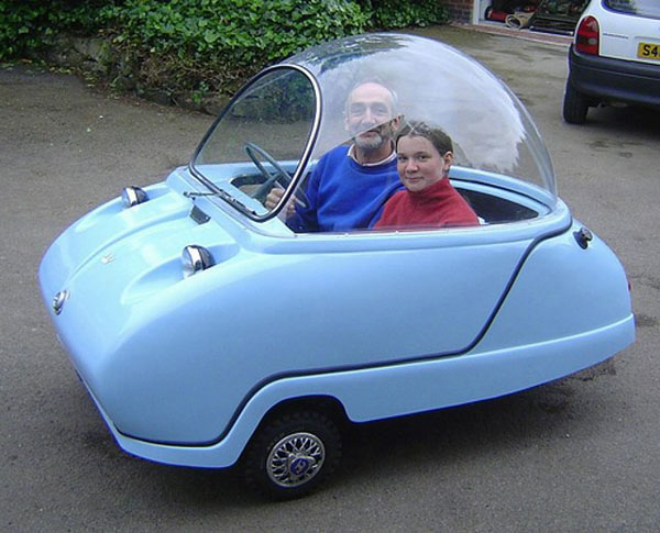 A couple sitting in a cool blue car.