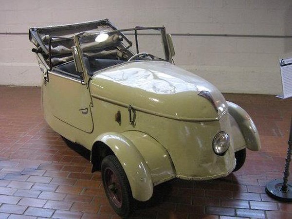 A vintage automobile is showcased in a museum from the Just Cool Ass Cars collection.