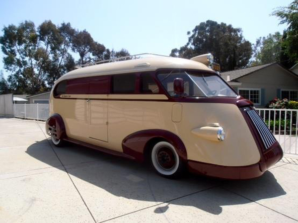 A beige and tan camper van parked Yup.