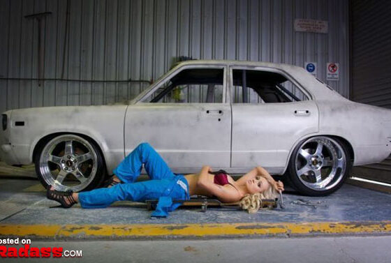 A girl lying on the ground next to a white car, a breathtaking combination of girls and cars.