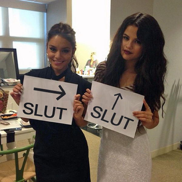 Selena Gomez graciously poses with signs that say 