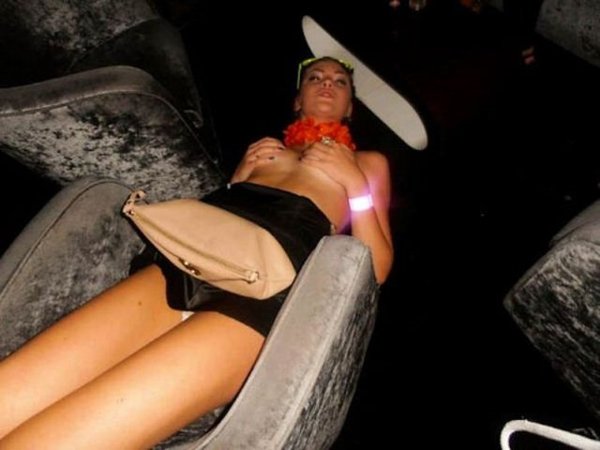 A woman lounging on a couch in a club, immersed in the atmosphere of 