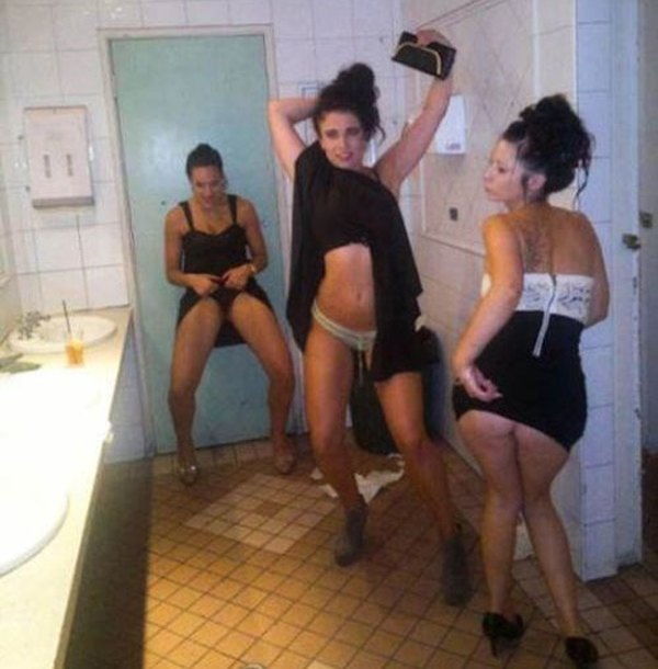 A group of women dancing in a bathroom, showcasing their talent and charisma.
