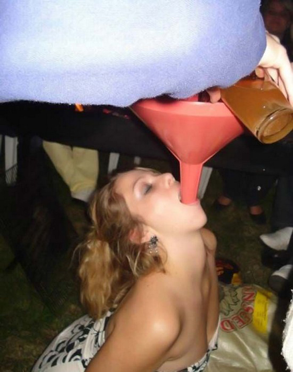 A woman drinking a beer from a funnel, showcasing her 