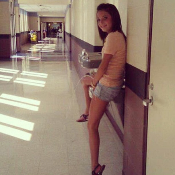 A girl leaning against a wall in a hallway with Keywords: date
