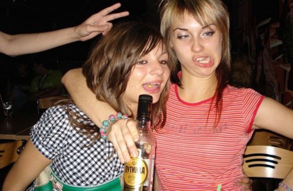 Two girls posing for a picture with I Would Date You But… (part 1) bottle of alcohol.