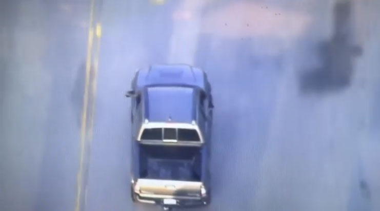 Description: A car captured from above as it cruises down the street in Los Angeles.