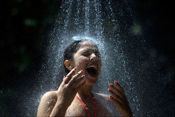 A woman experiences a refreshing shower.