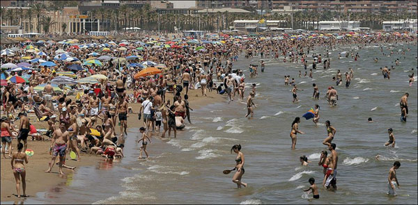 A beautiful crowd on a Barcelona beach in Spain.