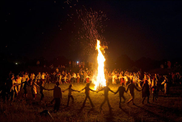 A group of people enjoying a bonfire night.
