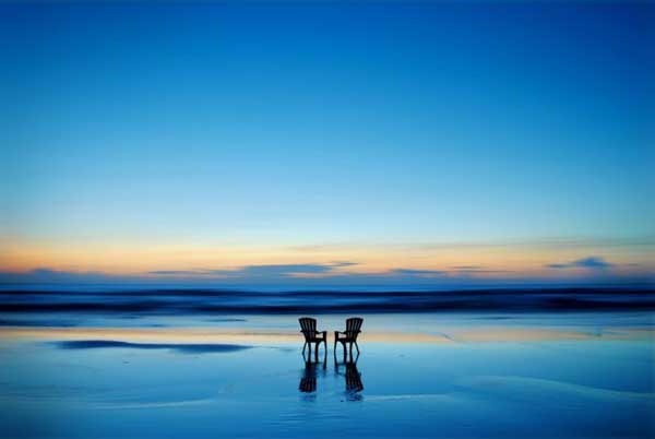 Two chairs sitting on the beach at sunset, captured for National Geographic Traveler's Magazine Photo Contest (40 Pics).