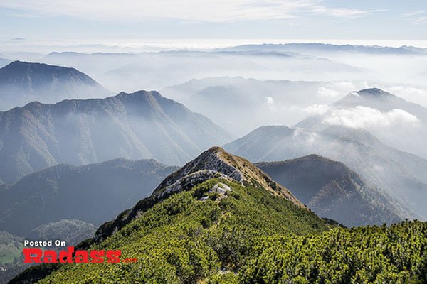 The top of a mountain is covered in clouds, and I think to myself, what a wonderful world.