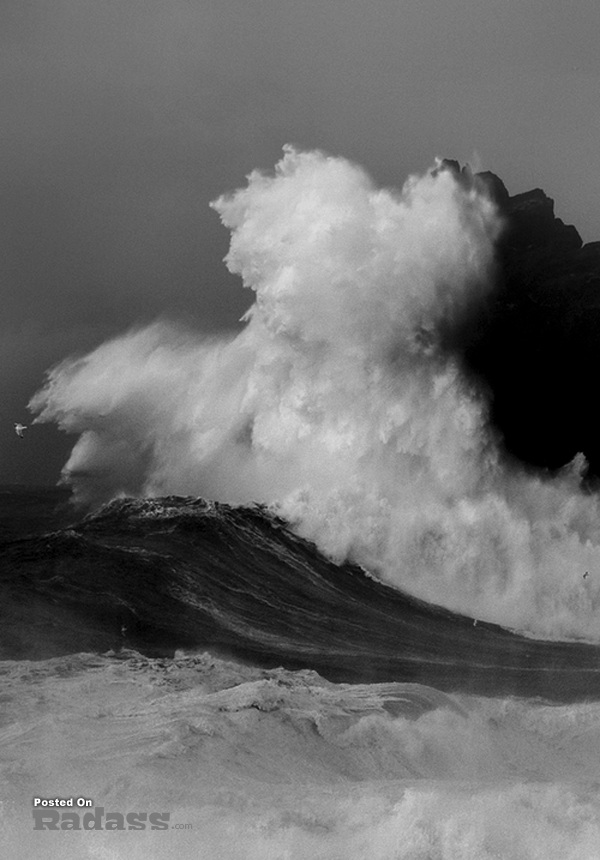 A black and white photo capturing the awe-inspiring power of a large wave, reminding me of what a wonderful world we live in.