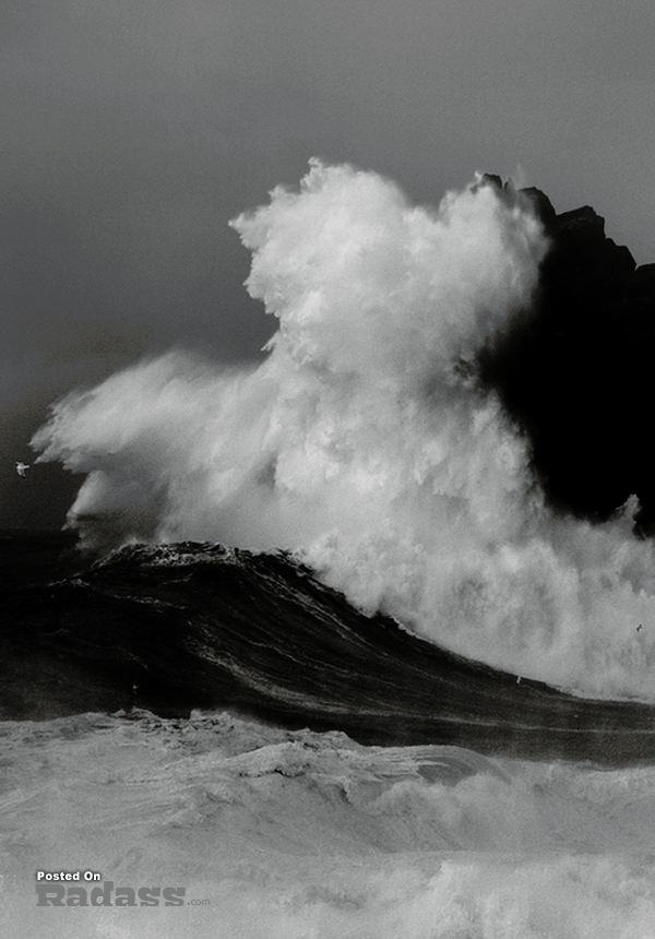 A black and white photo capturing the awe-inspiring power of a large wave, reminding me of what a wonderful world we live in.