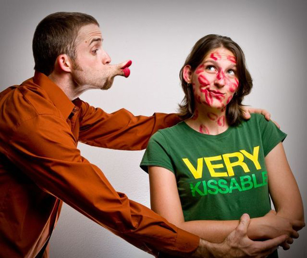 Thad and Sarah Lawrence, masters of photo manipulation, capture a captivating moment of a man kissing a woman with paint on his face.