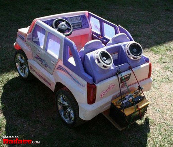 A pink and purple jeep with speakers in the back, perfect for blasting music while cruising.