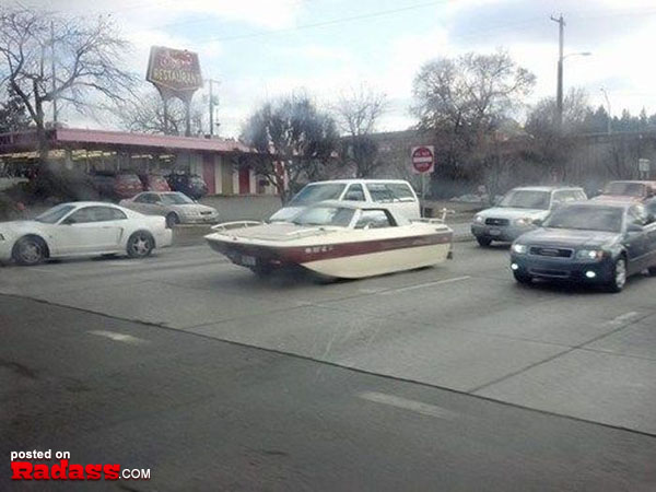 A boat stranded on the road, invoking Redneck ingenuity and resourcefulness.